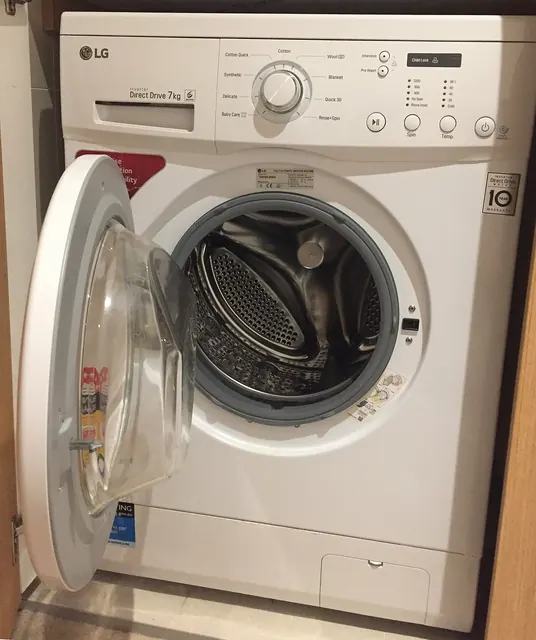 LG front-load washing machine with the door open showing the drum