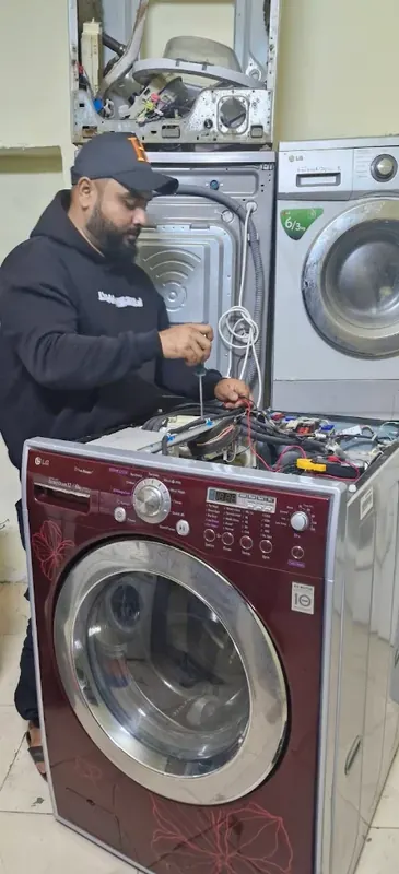 Technician repairing an LG front-load washing machine
